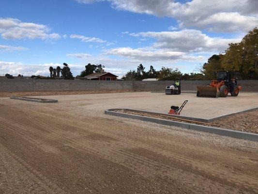 Grading being compacted before receiving asphalt.