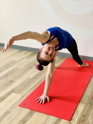 Jamie demonstrating a yoga pose. Find her class every Wednesday at 5:30pm in the Living Yoga Center.