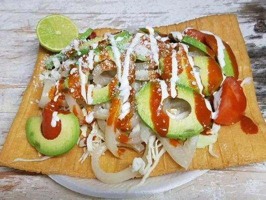 CHILINDRINAS -  flour chicharron - cabbagge - pork rinds - tomatoes - avocado -lime - hot sauce - powder cheese and sour cream