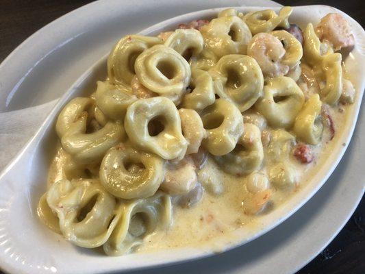 Tortellini with baby shrimp and roasted red peppers in a garlic butter cream sauce