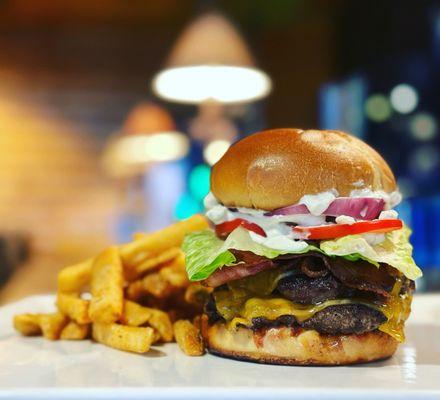 Enjoy two smashed beef patties, melted cheddar cheese, a delightful crunch of fried pickles, all topped off with our housemade bleu cheese.