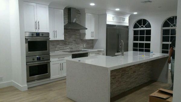 Amazing finish pure white quartz with white shake doors cabinets.