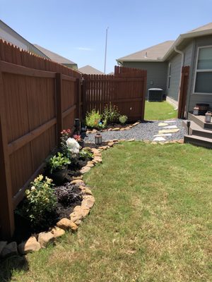 Corner of heaven - pollinator beds with rock pathway