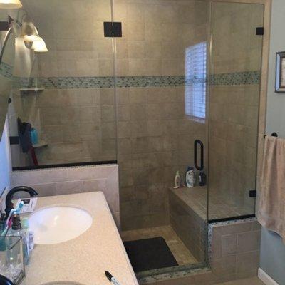 Recently completed shower  panel door panel frameless with wall clips in oil rubbed bronze