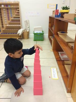 Working with the Pink Tower or Tower of Cubes.