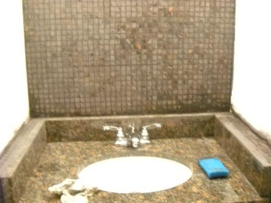 Glue, grout of tile (small area); faucet returned and counter top added.  THIS IS THE FINISH PRODUCT.