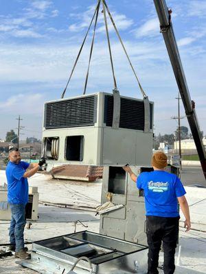 Crane set multiple unit replacements at a commercial building.