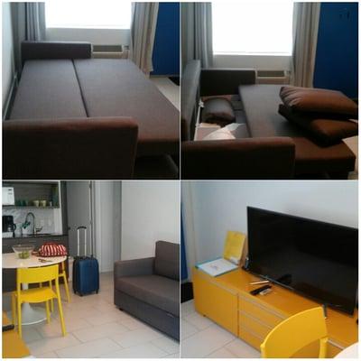 Living room w/ kitchenette. The sofa transforms into a futon