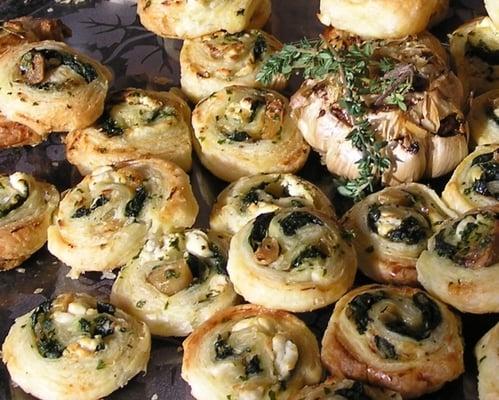 Puff pastry pinwheels with spinach & cheddar, and caramelized onions & Chevere