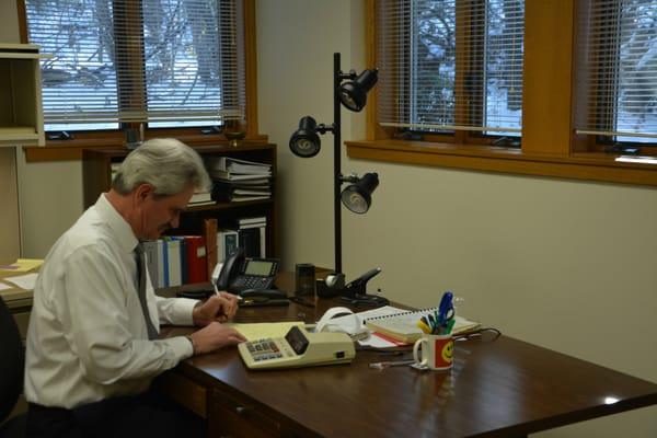 Tom Adler, CPA diligently running some numbers.