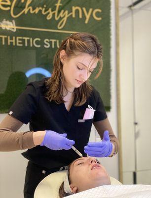 Nurse Emma applying PRP with a microneedling treatment.