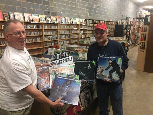 Dave helps Bob, April's Customer of the Month, pick out some box sets.