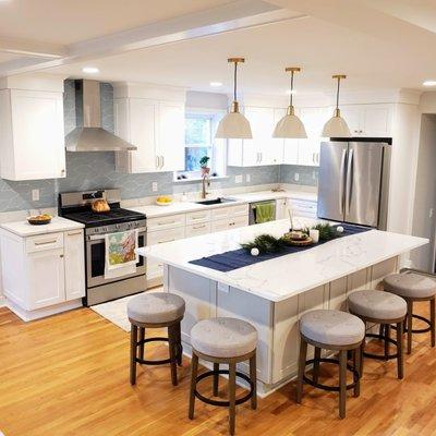 Kitchen remodel with quartz counter-tops, hardwood floors, removed a load bearing wall and replaced with a support beam to open up the room.