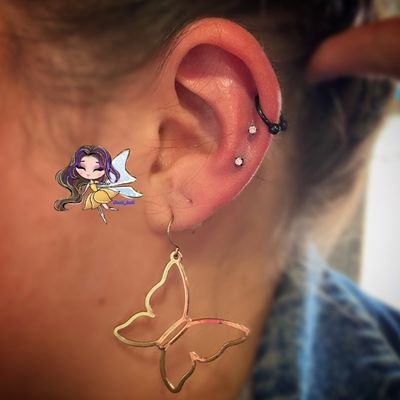 Two outer conch piercings