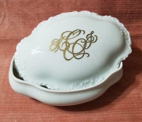 Custom monogram in gold on keepsake ceramic case.