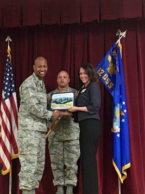 Receiving recognition from Commander of the 62nd Airlift Wing, OSS. Becoming an Honorary Commander!