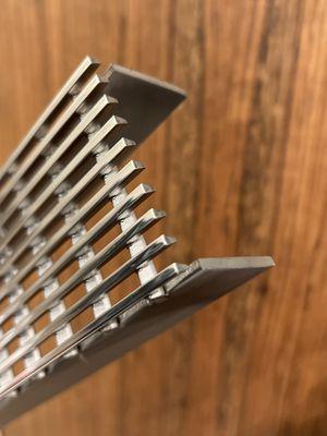 Stainless steel drain grate, perfectly and cleanly cut to size.