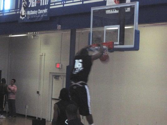 Yancy Gates, a freshman at UC, dunks the ball during warm-ups. Six of his 13 points in the opening game came off of dunks.