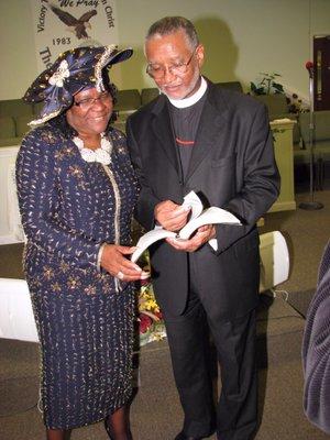 Pastor Cordon showing First Lady Cordon some Scriptures.