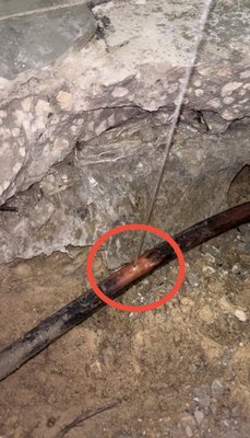 Hole in copper pipe located underneath the slab