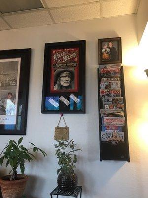 Willie Nelson poster from a 2016 show and some reading materials in the waiting room.