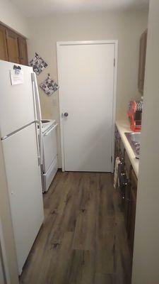 Small kitchen but still lots of cabinet spaces and that door is a walk in pantry!