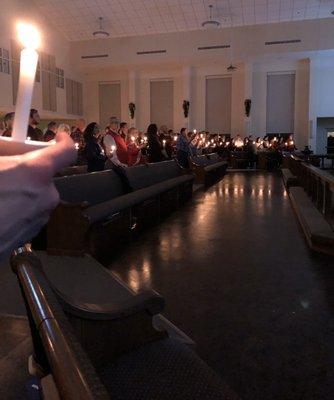 Congregation singing Silent Night by candlelight during the Christmas Eve Service 2019