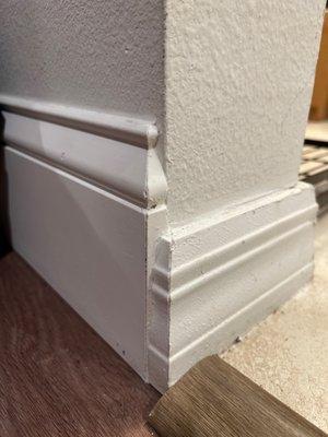 Elegant transition between tile with 3.25" baseboard and vinyl with 5.25" baseboard