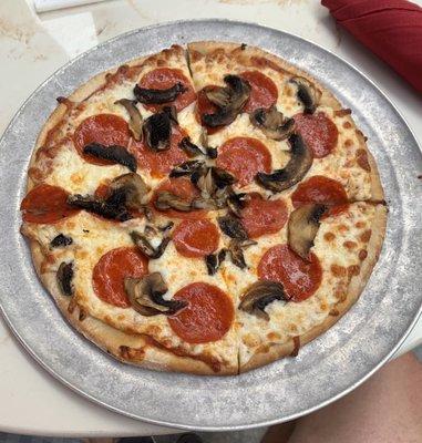 Pepperoni and mushroom with a little extra sauce.