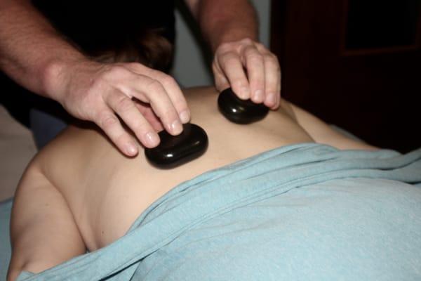 Hot stones included with each massage promote  relaxation and healing.