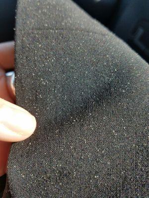 Tiny white fibers on black pants