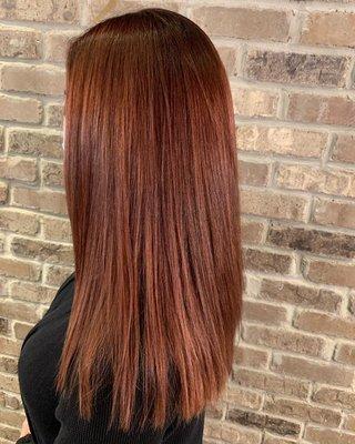 Chic custom red hair color and haircut by Callie. Visit our salon outside of Chicago for your blowout, bridal hair, highlights and more!