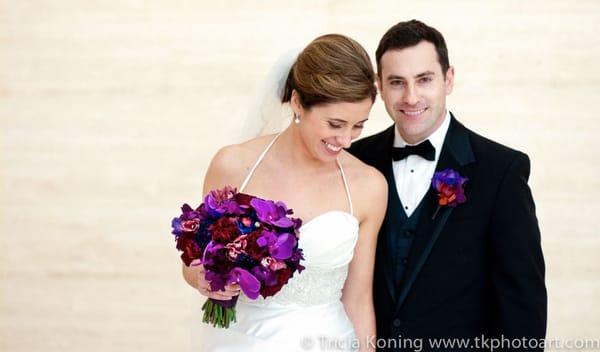 bride candid smile with beautiful purple bouquet