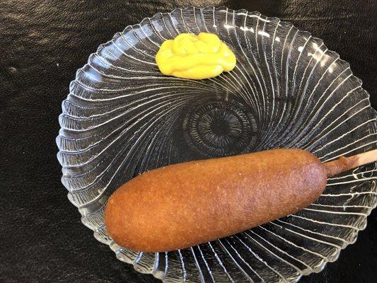 Corndog with mustard.