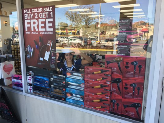 One Beauty Consultant poses in the window during our 50% Off Clearance Sale!