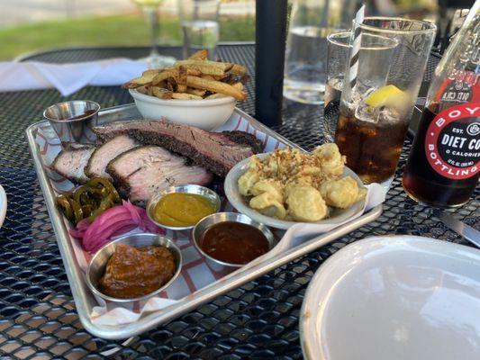 Platter with pork belly and brisket with side of fries and Mac and cheese