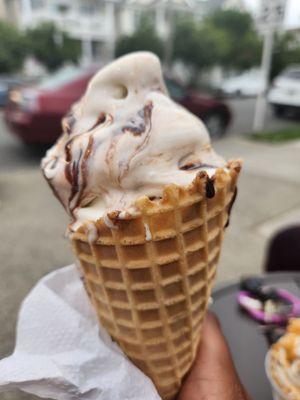 Cone with chocolate and marshmallow drizzle.