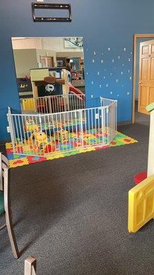 Infant area, safety gated from the bigger kids playing.