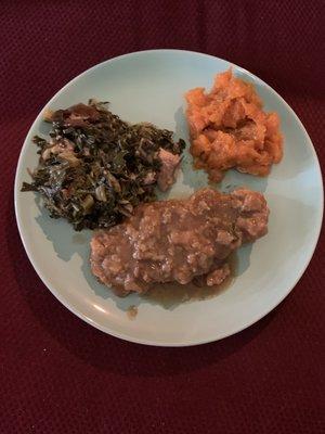 Smothered Pork Chops with Sweet Potatoes and Collard Greens.