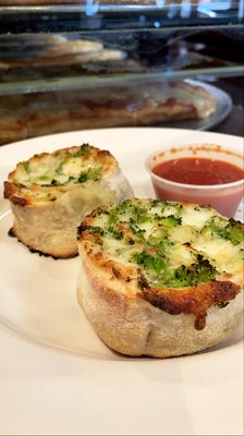 Broccoli pinwheel served with tomato sauce