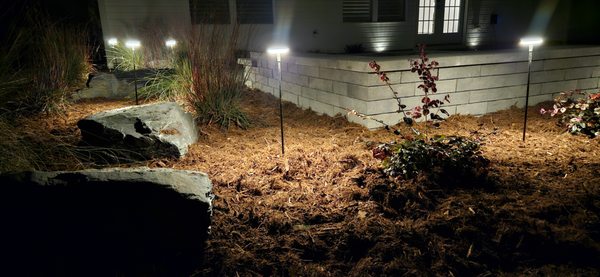 landscape lighting, outdoor lighting, low voltage lighting, landscape mulch, ornamental grasses, decorative  stone, hardscape sitting area,