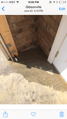 No drain between the driveway and the garage. No way to stop water. Water coming under garage door from the driveway.