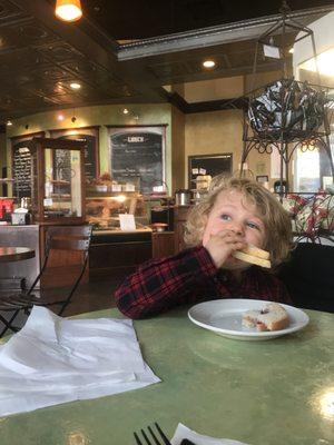 My kid happily eating with Mr Grumpy Pants in the back.