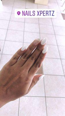 Almond white nails with a splash of sparkles