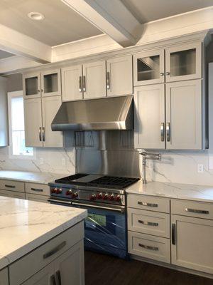 Shaker door with slab drawer front.  Painted grey.