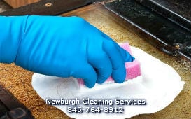 maid and house cleaning service from Newburgh Cleaning Services (845) 764-8912 scrubbing a filthy oven during a thorough kitc...