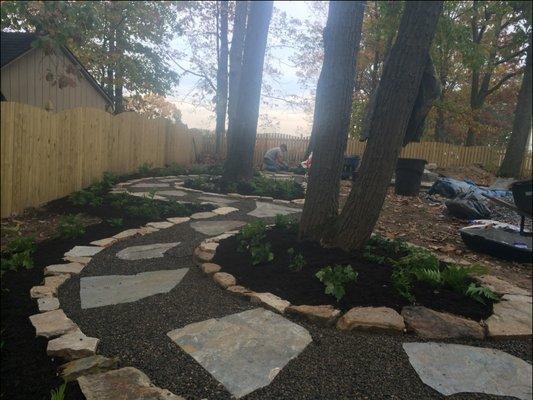 a beautiful backyard path through the trees creates interest.