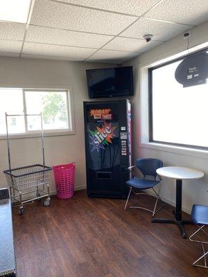 More waiting area with beverage machine and television