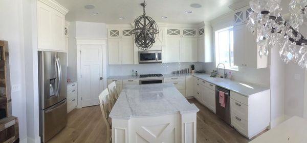 White kitchen cabinets with Carrera Marble.