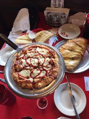 Calzone, bread sticks, BBQ chicken pizza, ice tea